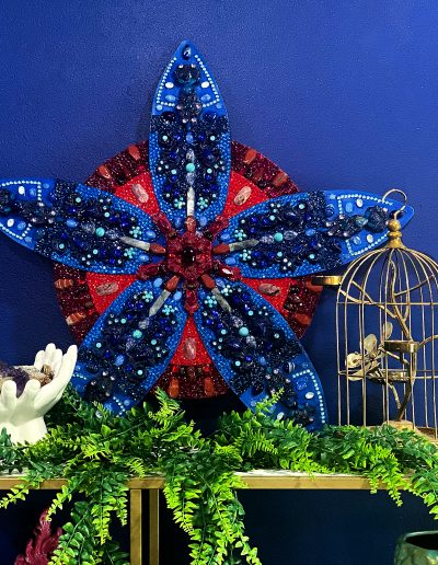 Flower sculpture on a shelf with decor items