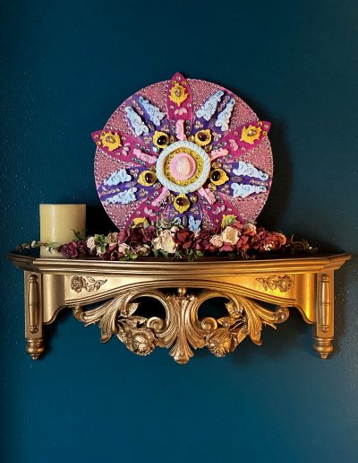 Flower sculpture on a shelf with decor items