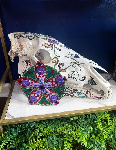 Flower sculpture on a shelf with other decor items