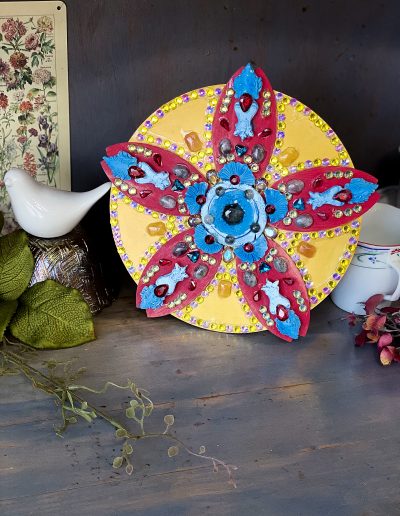 Flower sculpture on a shelf with decor items