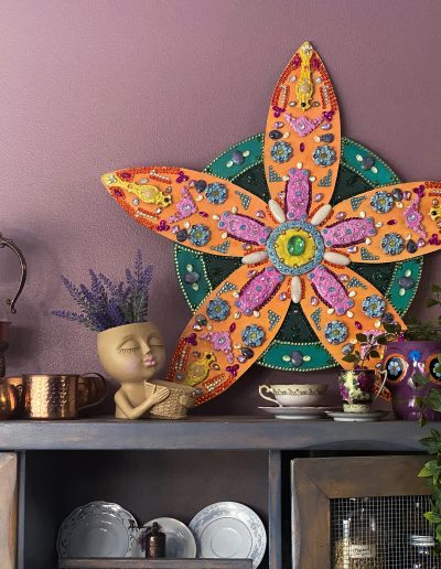 Flower sculpture on a shelf with decor items