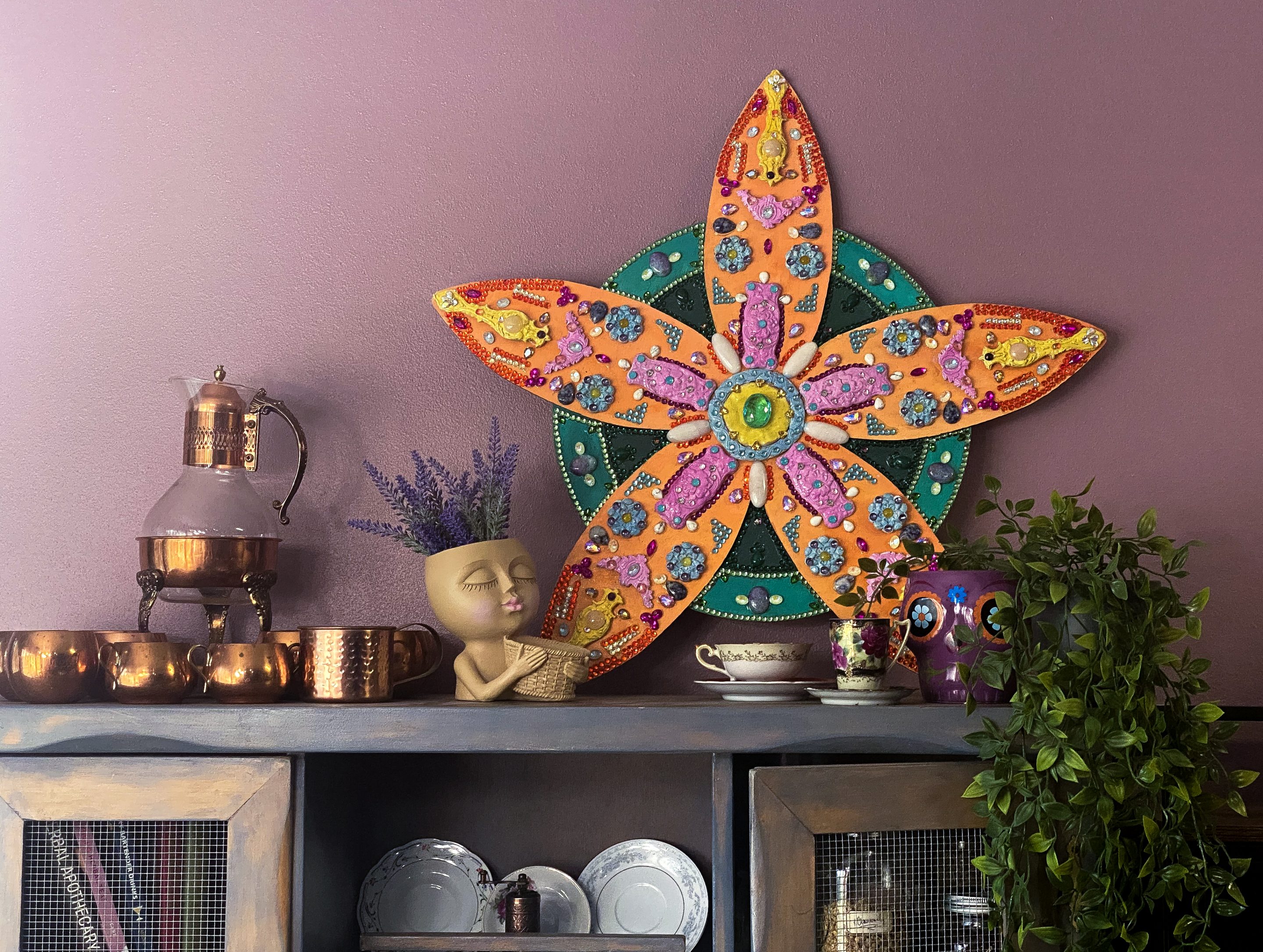 large flower sculpture on hutch Flower sculpture on a shelf with decor items