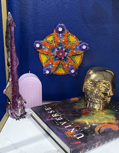 Flower sculpture on the wall with decor items